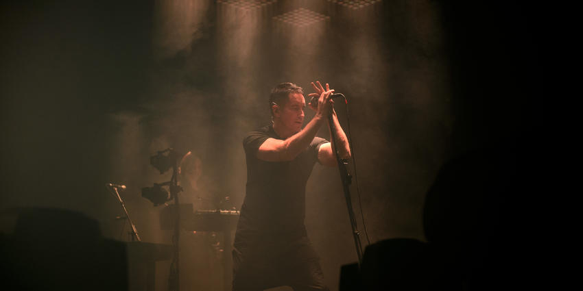 Nine Inch Nails vocalist performs under spot lights and in fog during their concert at the BJC in 2013.