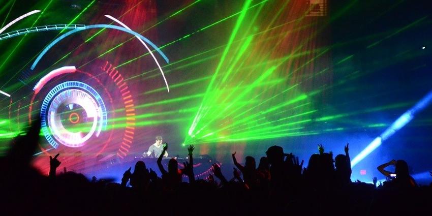 Hardwell, DJ, mixes beats on stage under a rainbow of laser and strobe lights for the dancing BJC crowd.