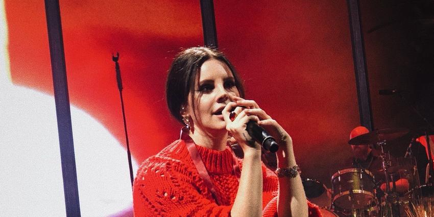 Lana Del Rey sits on stage singing during her performance at BJC