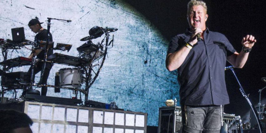Rascal Flatts lead singer, Gary LeVox, sings into hand held microphone during their concert at the BJC in 2016
