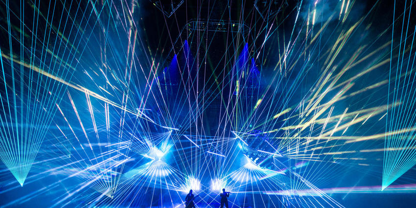TSO perform electric rock opera with hundreds of blue strobe lights flashing in unison all across the stage