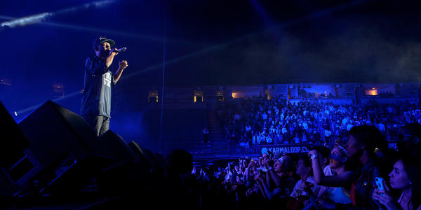 Kendrick Lamar raps on stage for the crowd at the Bryce Jordan Center in 2013.