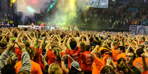 Standing with the dancers of THON watching a live performance on stage during THON 2014.