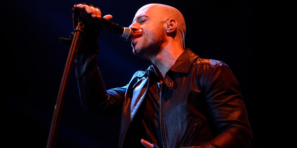 Lead singer of Daughtry sings into standing microphone during their concert at the Bryce Jordan Center in 2012.