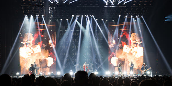 Long shot of entire stage and white light beam display while Florida Georgia Line performs on stage. 