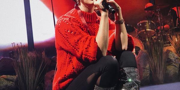 Lana Del Rey sits on stage singing during her performance at BJC
