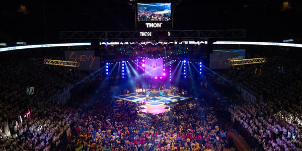 All dancers on floor and crowds in seats watching the stage