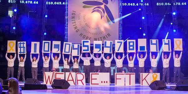 Reveal of amount raised on stage.  Each Thon member holds a number above their head.